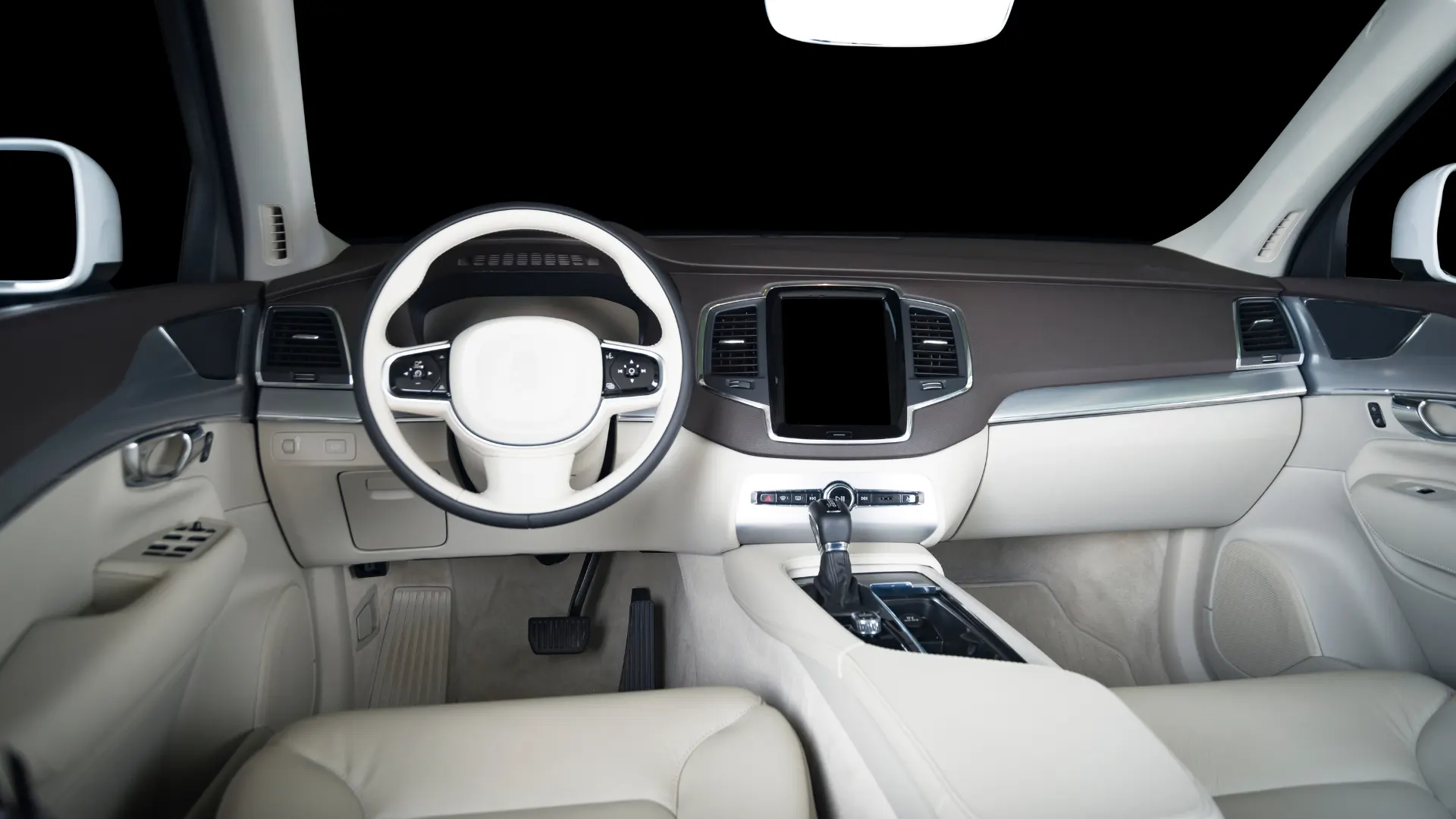 The interior of a luxury automobile lit up really bright